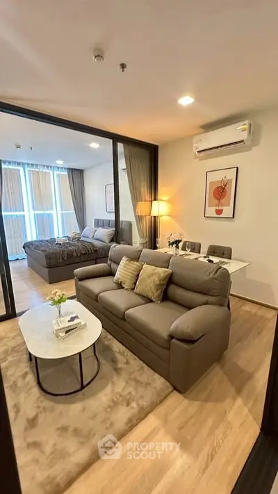 Modern living room with cozy sofa and stylish decor in open-plan apartment