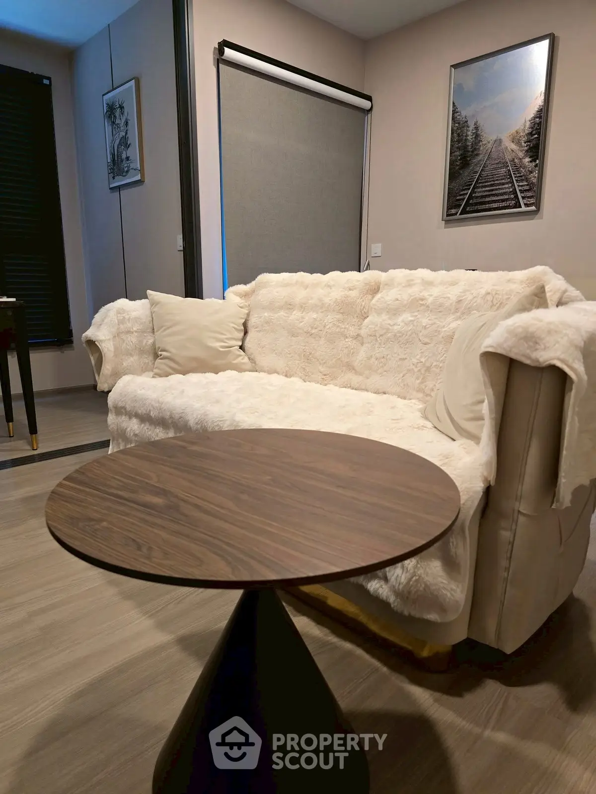 Cozy living room with plush sofa and modern round table