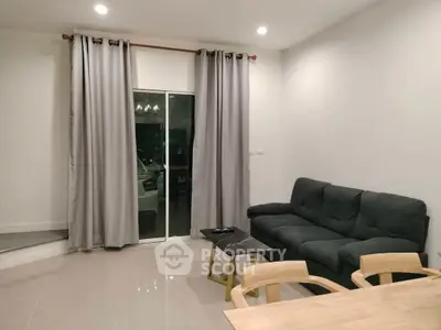 Modern living room with cozy seating and elegant curtains