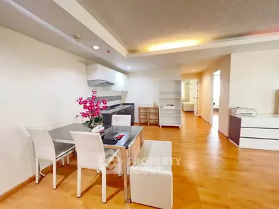 Spacious open-plan living and dining area with modern kitchen and elegant decor.