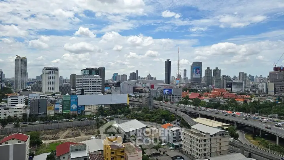 Stunning cityscape view showcasing urban skyline and bustling highways under a vibrant blue sky.