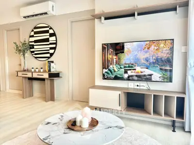 Modern living room with stylish decor and wall-mounted TV