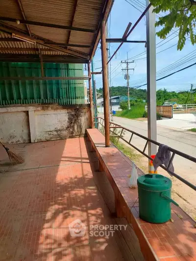 Spacious outdoor area with tiled flooring and scenic view, perfect for relaxation or gatherings.