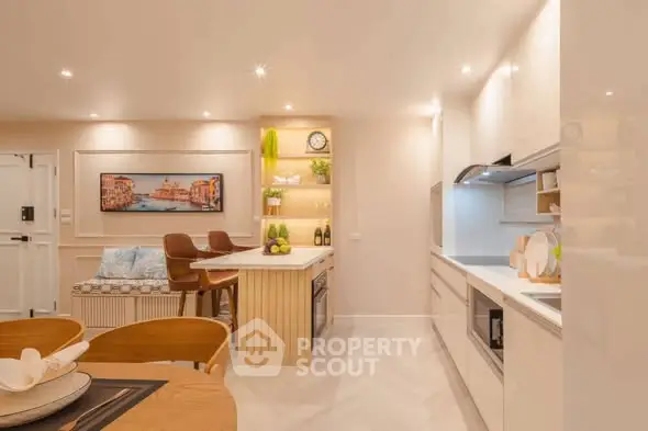 Modern kitchen with open layout and stylish decor, featuring sleek cabinetry and ambient lighting.