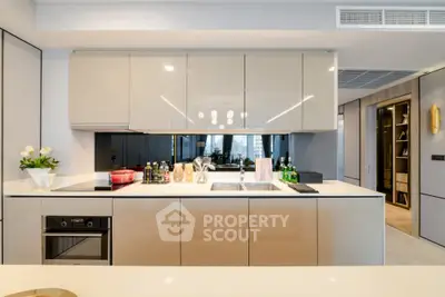 Modern kitchen with sleek cabinetry and built-in appliances, featuring a minimalist design.