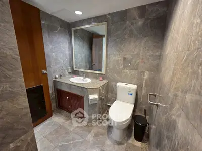 Modern bathroom with elegant stone tiles and sleek fixtures