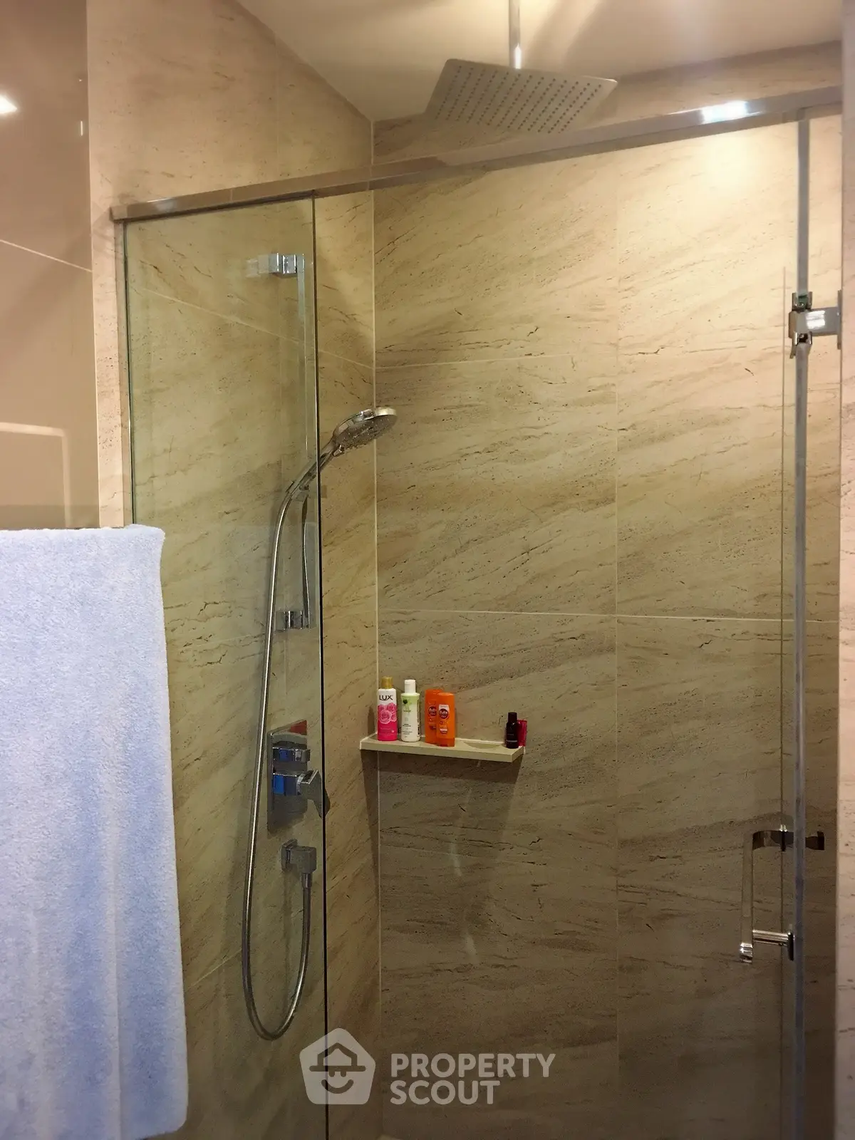 Modern bathroom with glass shower enclosure and rainfall showerhead