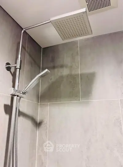 Modern bathroom with sleek showerhead and contemporary tile design