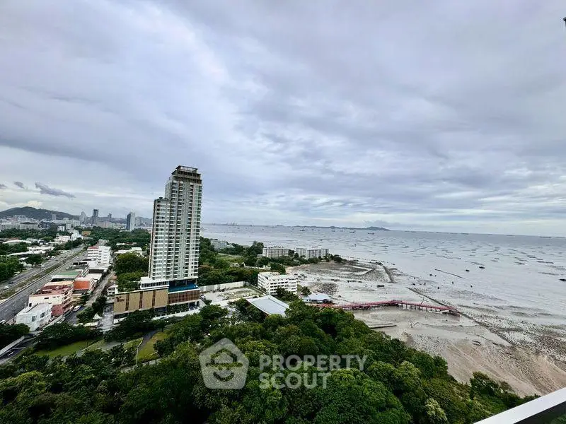 Stunning high-rise building with panoramic ocean view and lush greenery, perfect for luxury living.