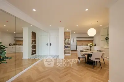 Spacious modern dining area with elegant wooden flooring and stylish decor