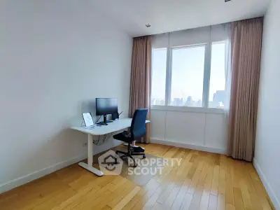 Bright study room with city view, featuring modern desk and chair, ideal for productivity.