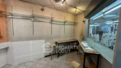 Commercial retail space with shelving and display window in shopping center