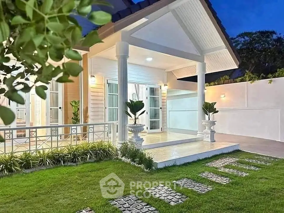 Charming modern house with elegant entrance and lush garden, perfect for serene living.