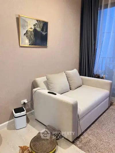 Cozy living room with modern sofa and elegant wall art, perfect for relaxation.
