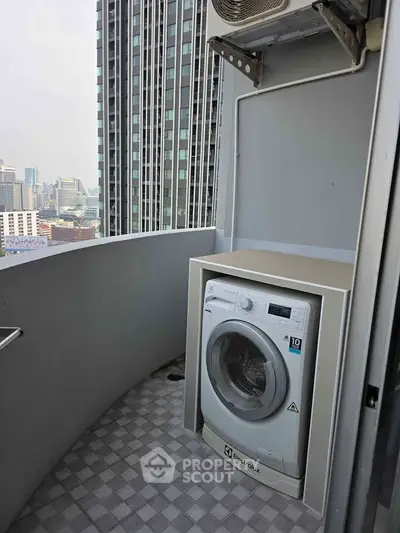 High-rise balcony with city view and washing machine setup