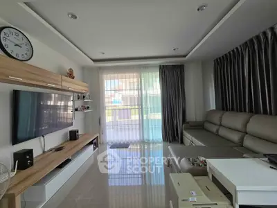 Modern living room with sleek furniture and large windows for natural light.
