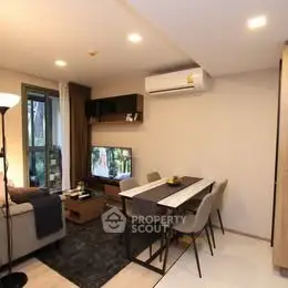 Modern living room with dining area and stylish decor in a cozy apartment.