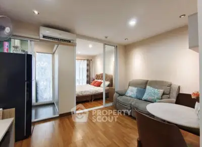 Modern open-plan living room with cozy bedroom and sleek furnishings