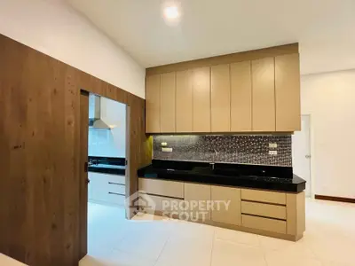 Modern kitchen with sleek cabinetry and stylish backsplash in a contemporary home.