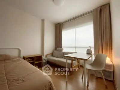 Cozy bedroom with natural light, featuring a bed, sofa, and study desk in a minimalist design.