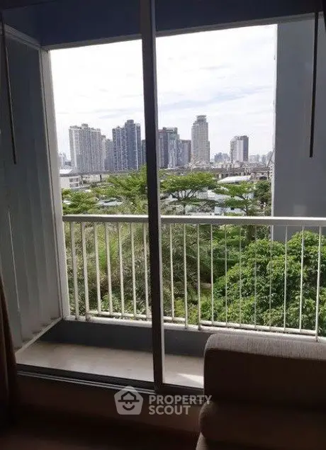 Stunning cityscape view from a cozy apartment balcony, perfect for urban living enthusiasts.