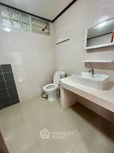 Spacious bathroom with modern fixtures and elegant tile design, perfect for a comfortable living experience.