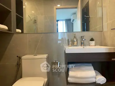 Modern bathroom with sleek fixtures and ample storage in a stylish apartment.