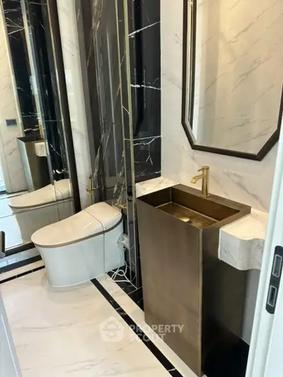 Luxurious modern bathroom with elegant gold fixtures and marble accents