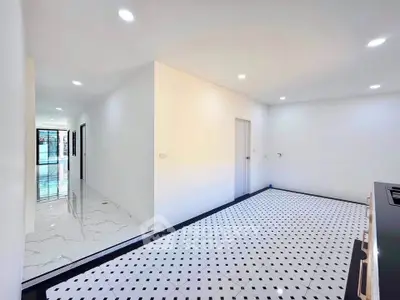 Spacious modern interior with sleek flooring and bright lighting, perfect for contemporary living.