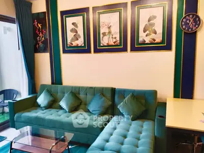 Stylish living room with green sofa and elegant wall art