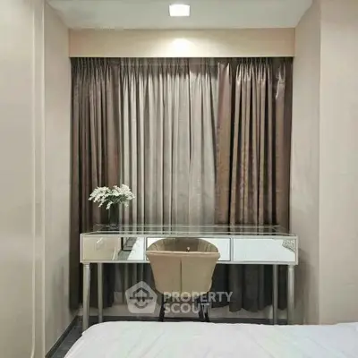 Elegant study nook with glass desk and beige chair, perfect for productivity and style.