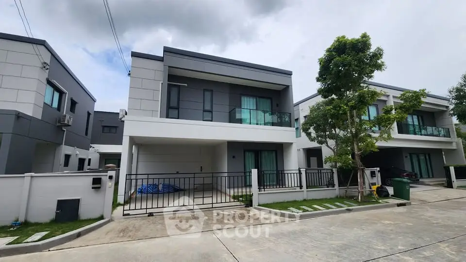 Modern two-story houses with sleek design and spacious driveways in a suburban neighborhood.