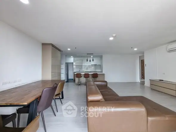 Spacious modern living room with open kitchen and stylish furniture