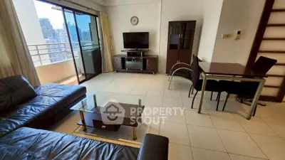 Spacious living room with modern furniture and city view balcony
