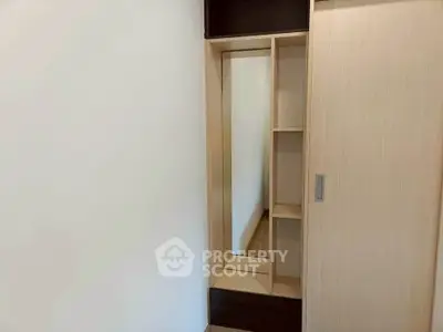 Modern wardrobe with sliding doors and mirror in a minimalist bedroom