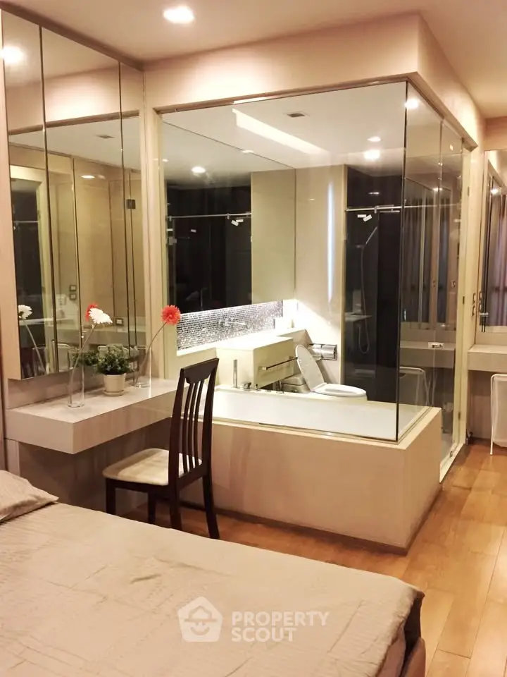 Luxurious bedroom with glass-enclosed bathroom and elegant decor