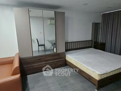 Modern bedroom with sleek furniture and cozy ambiance