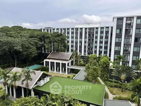 Modern apartment complex with lush greenery and pool view