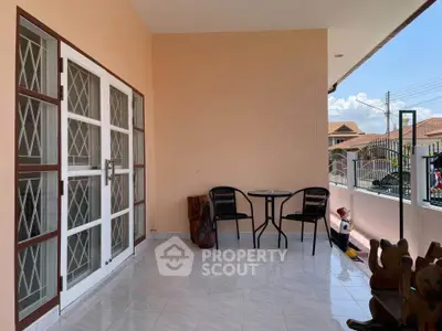 Spacious balcony with seating area and decorative elements, perfect for relaxation.