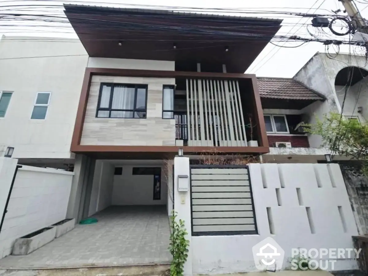 Modern two-story house with unique facade and spacious driveway