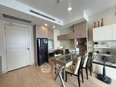 Modern kitchen with dining area, sleek cabinets, and stylish decor