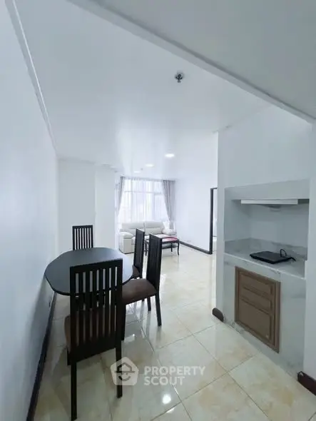 Spacious dining area with modern kitchen in open layout apartment