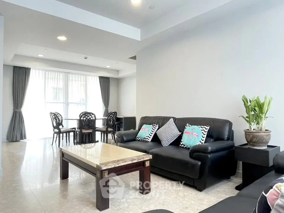 Spacious living room with elegant decor and ample natural light