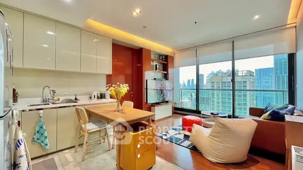 Modern open-layout kitchen and living room with city view, featuring sleek cabinetry and cozy seating.