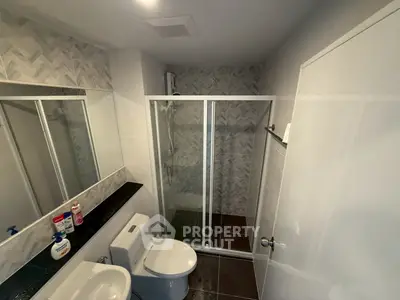 Modern bathroom with glass shower and sleek tile design