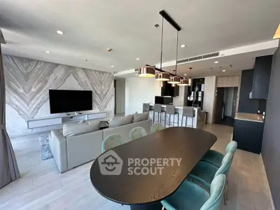Spacious modern living room with open kitchen and stylish dining area in luxury apartment.