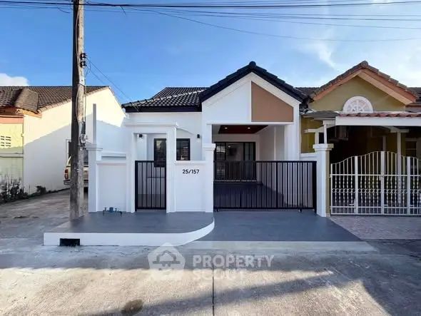Charming single-story home with modern facade and gated entrance in a serene neighborhood.