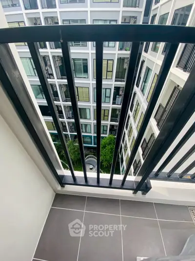 Modern apartment balcony with city view and sleek railing design