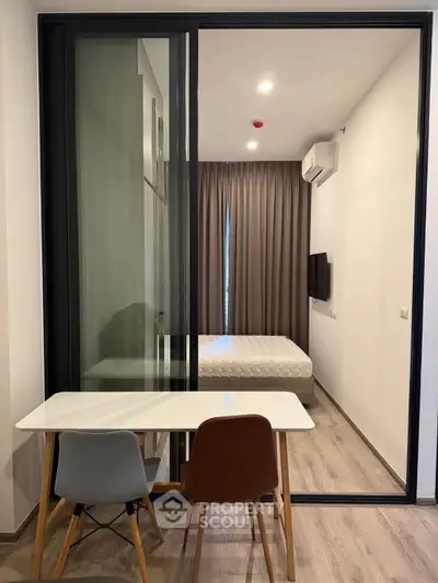 Modern bedroom with glass partition and minimalist furniture