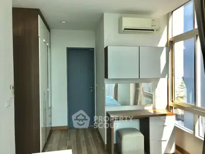 Bright modern bedroom with large windows and sleek furniture